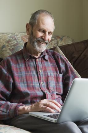 man sitting with his laptop open