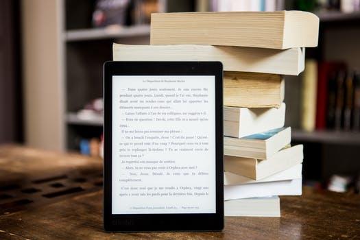 Stack of books with an ipad in front