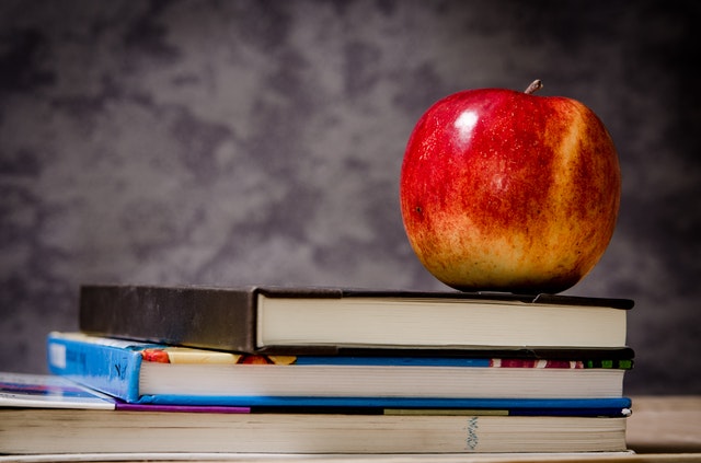An apple on top of books